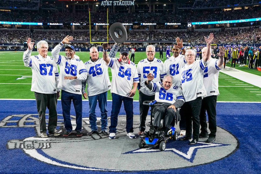 Nine members of the 1975 Dallas Cowboys “Dirty Dozen” are recognized during a timeout during...