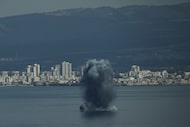 An incoming projectile explodes over the water as Israel issues a nationwide alert following...