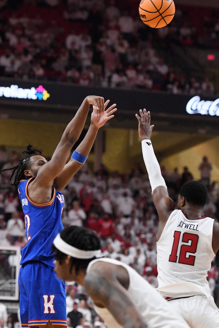 Kansas guard Darryn Peterson, left, shoots a 3-point basket during the second half of an...