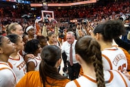 Texas head coach Vic Schaefer, center, gathers his team after competing against Oklahoma in...