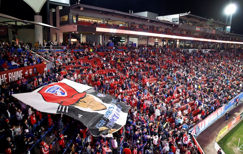 A huge painted tifo depicting new FC Dallas head coach Eric Quill is unfurled and handed...