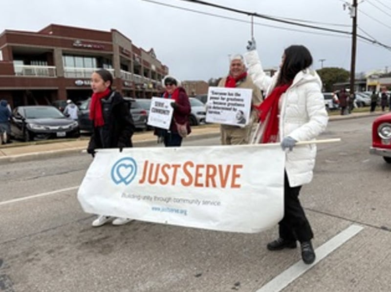 Volunteers walk through Martin Luther King Jr. Day parade on Saturday Jan. 17, 2025, in Carrollton, Texas.