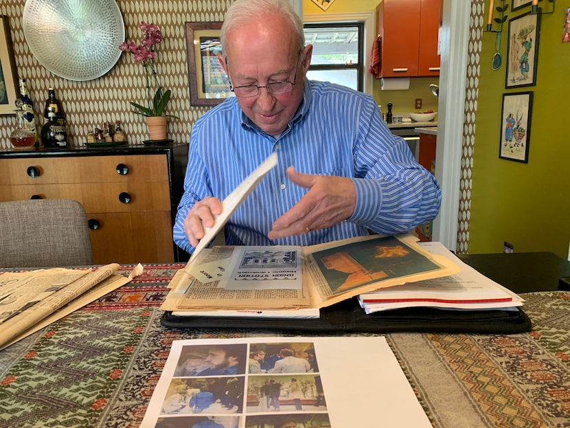 David Voss flips through his files and folders commemorating his time with the city, during...