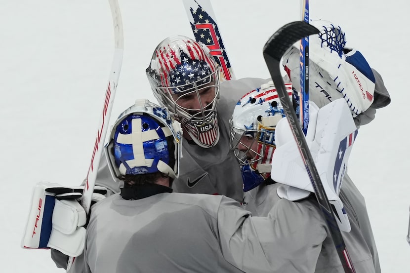 United States goalkeepers Connor Hellebuyck, Jake Oettinger, and Jeremy Swayman, gather on...