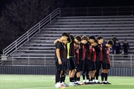 The starting 11 for Woodrow Wilson soccer team bowed their heads during a moment of silence...