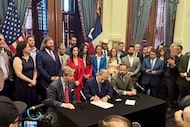 Texas Gov. Greg Abbott, seated between state Sen. Tan Parker, R-Flower Mound, and House...