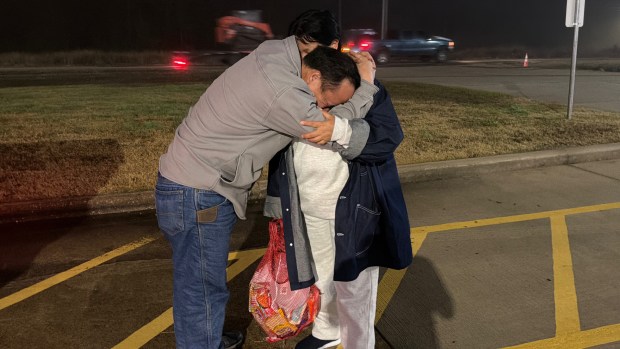 After spending two weeks in federal detention, Thi Dua Vang, right, tearfully embraces her husband, A Pao Giang, outside a federal facility in Houston, Texas on Jan. 21, 2026. (Courtesy of Wa Chi Minh Vang)