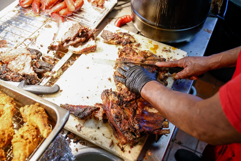 Lorenzo Brightman slices ribs for customers at Sweet Georgia Brown, Sunday, Feb. 1, 2026, in...