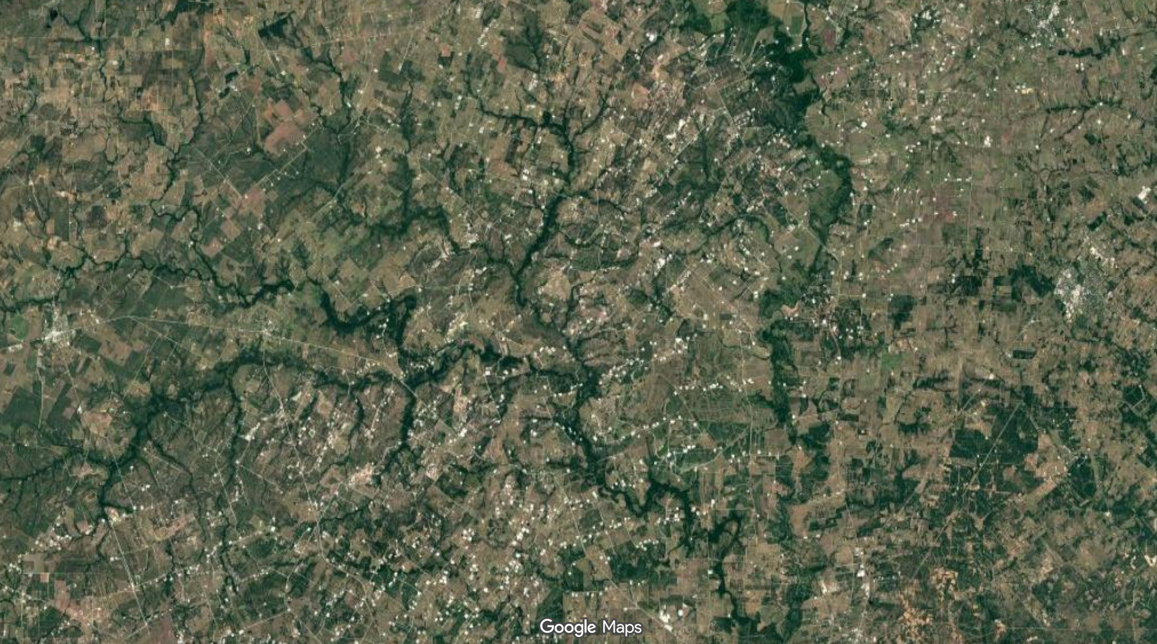 A glitter of white oil well pads marks the Eagle Ford Shale where it’s crossed by Sandies Creek and the Guadalupe River. Credit: Satellite imagery from Google Maps