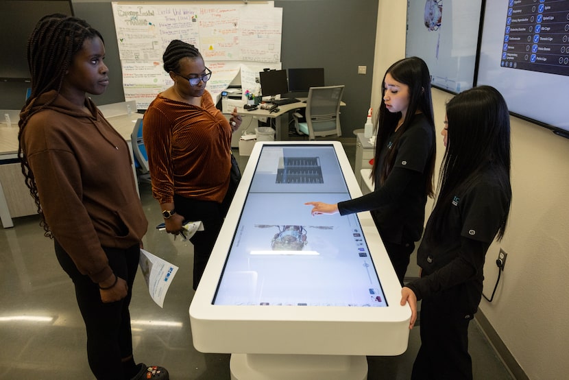 Adaora Umeh and daughter Weluchu Umeh, a sophomore, learn about a digitized cadaver used by...