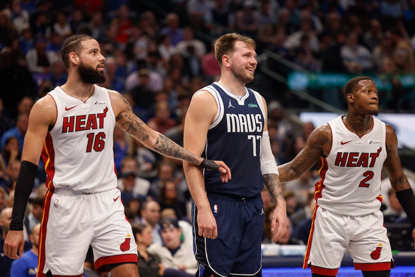 Dallas Mavericks guard Luka Doncic (77) smiles during a free throw alongside Miami Heat...