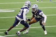 Dallas Cowboys cornerback Shavon Revel Jr.(24) covers fellow cornerback Robert Rochell (30)...