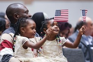 Simon Bingila shares a moment with his twin daughters, Johanna, 2, (left) and Olivia, after...
