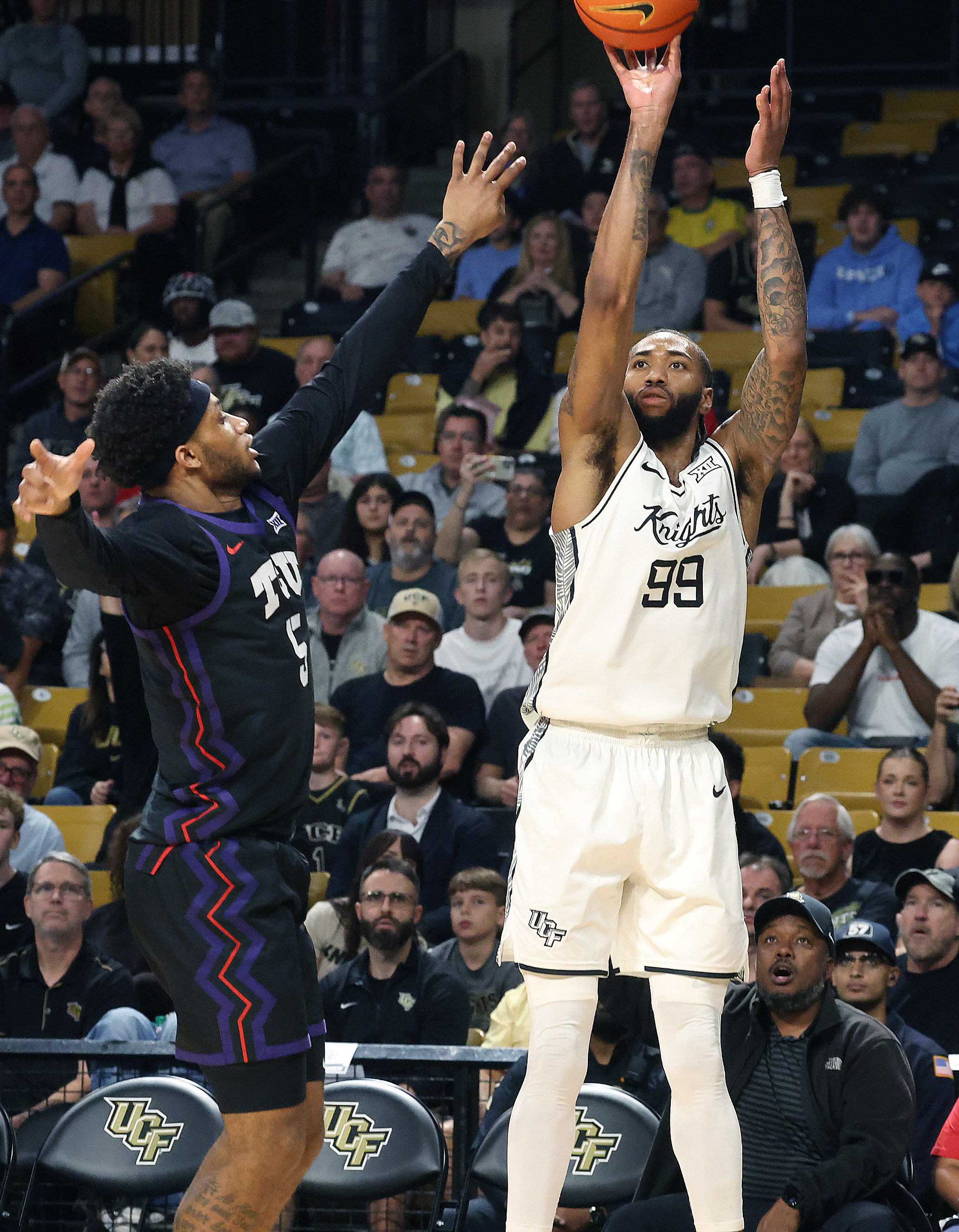 UCF forward Jordan Burks (99) shoots a three point shot...