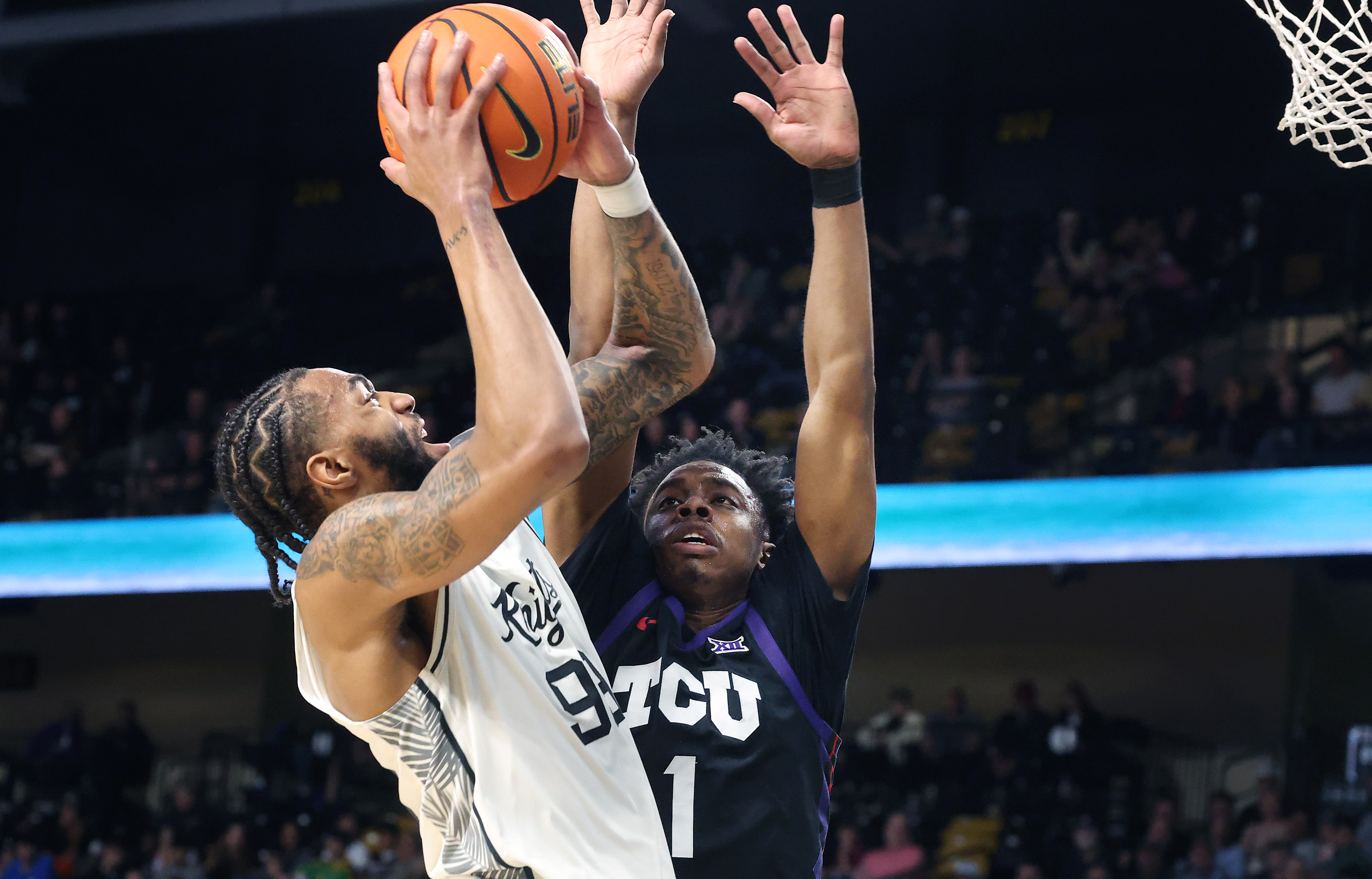 UCF forward Jordan Burks (99) scores over TCU guard Jayden...