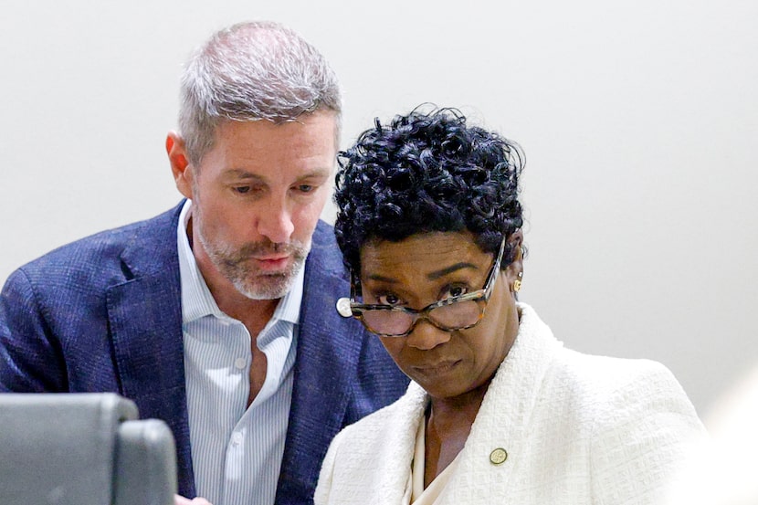 Dallas City Council member Chad West (left) talks with City Manager Kimberly Bizor Tolbert...