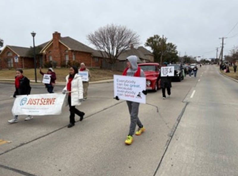Volunteers walk through Martin Luther King Jr. Day parade on Saturday Jan. 17, 2025 in Carrollton, Texas.