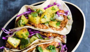 This image released by Milk Street shows a recipe for tacos made with broiled pork tenderloin tenderized with fresh pineapple. (Milk Street via AP)