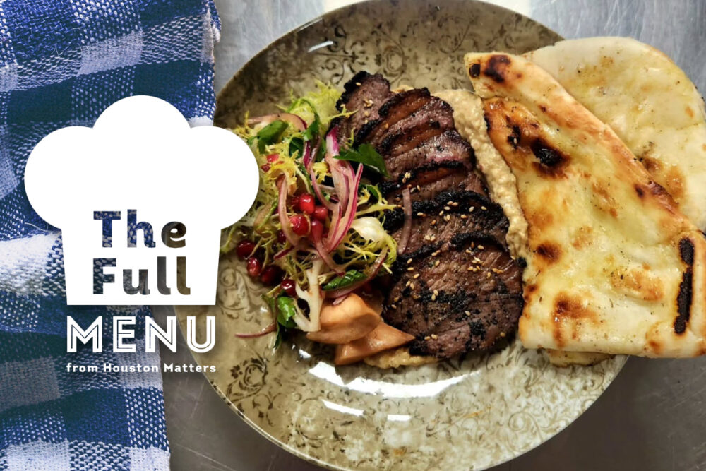 Lamb, eggplant, and grilled naan on a plate