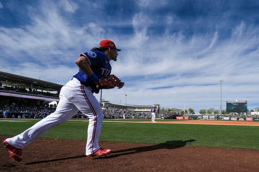 Texas Rangers outfielder Alejandro Osuna takes the field for the fifth inning of a spring...