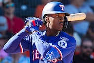 Texas Rangers infielder Sebastian Walcott bats during the seventh inning of a spring...