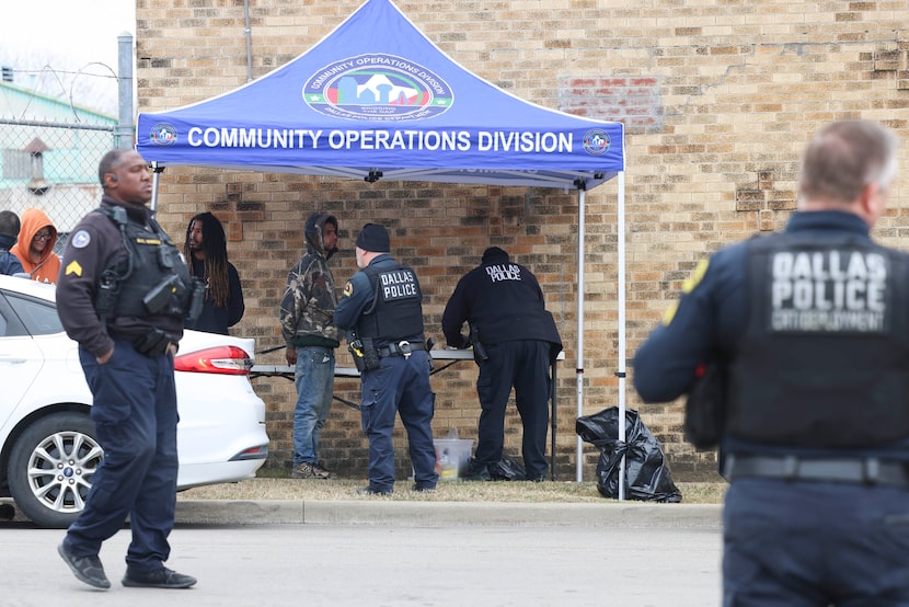 Dallas police officers conduct an enforcement operation by the premises of The Human Impact,...