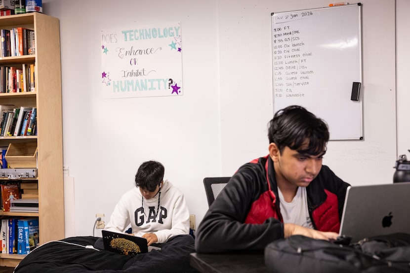 (From left) High school students Sajeed Lakhani and Rishi Santosh work on their laptops...