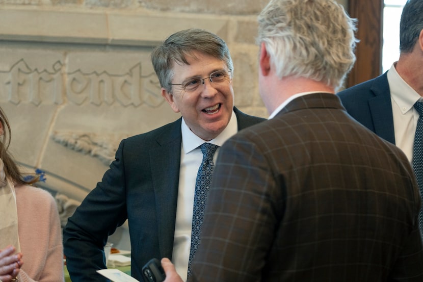 The Rev. Paul Rasmussen speaks with parishioners after his last sermon as senior pastor of...