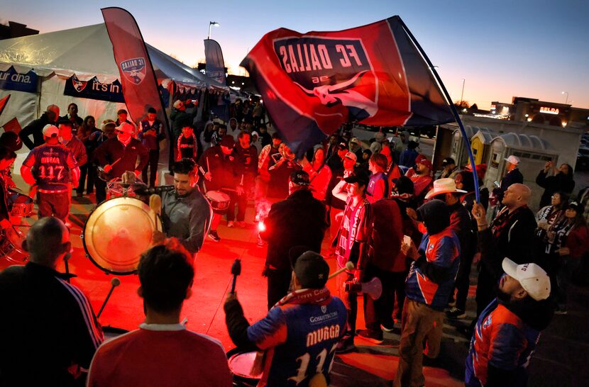 FC Dallas supporters sing, chant and beat drums after spending nearly 24 hours before the...