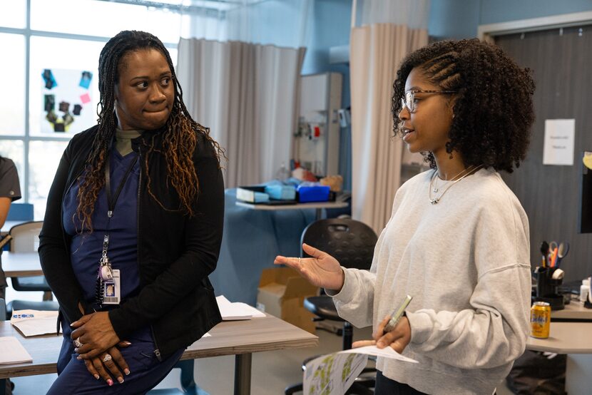 Medical Assistant and EKG instructor Keisha Wilson listens to high school junior Madalyn...