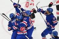 United States players celebrate after scoring a goal against Canada during the third period...