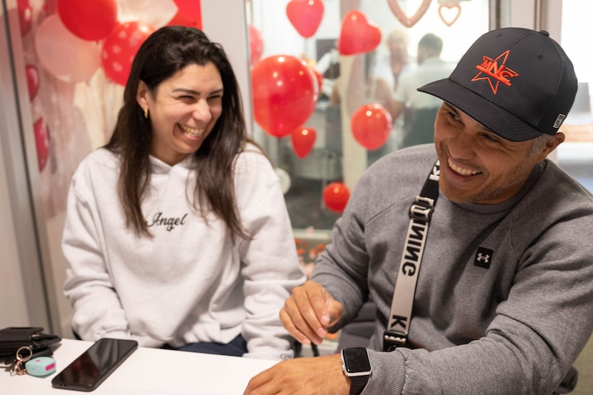 (From left) Adriana Rivas and Andry Lopez share a laugh as they apply for a marriage license...