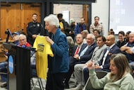 Phyllis Silver with DART Citizens Advisory Committee shows a shirt in support of DART during...