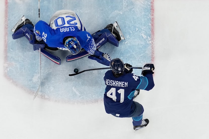 Italy's goalkeeper Damian Clara makes a save against Finland's Miro Heiskanen during a...