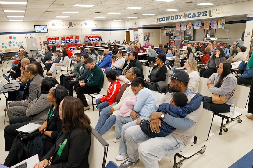 People attend a community meeting about school closures at Dickinson Montessori Academy,...