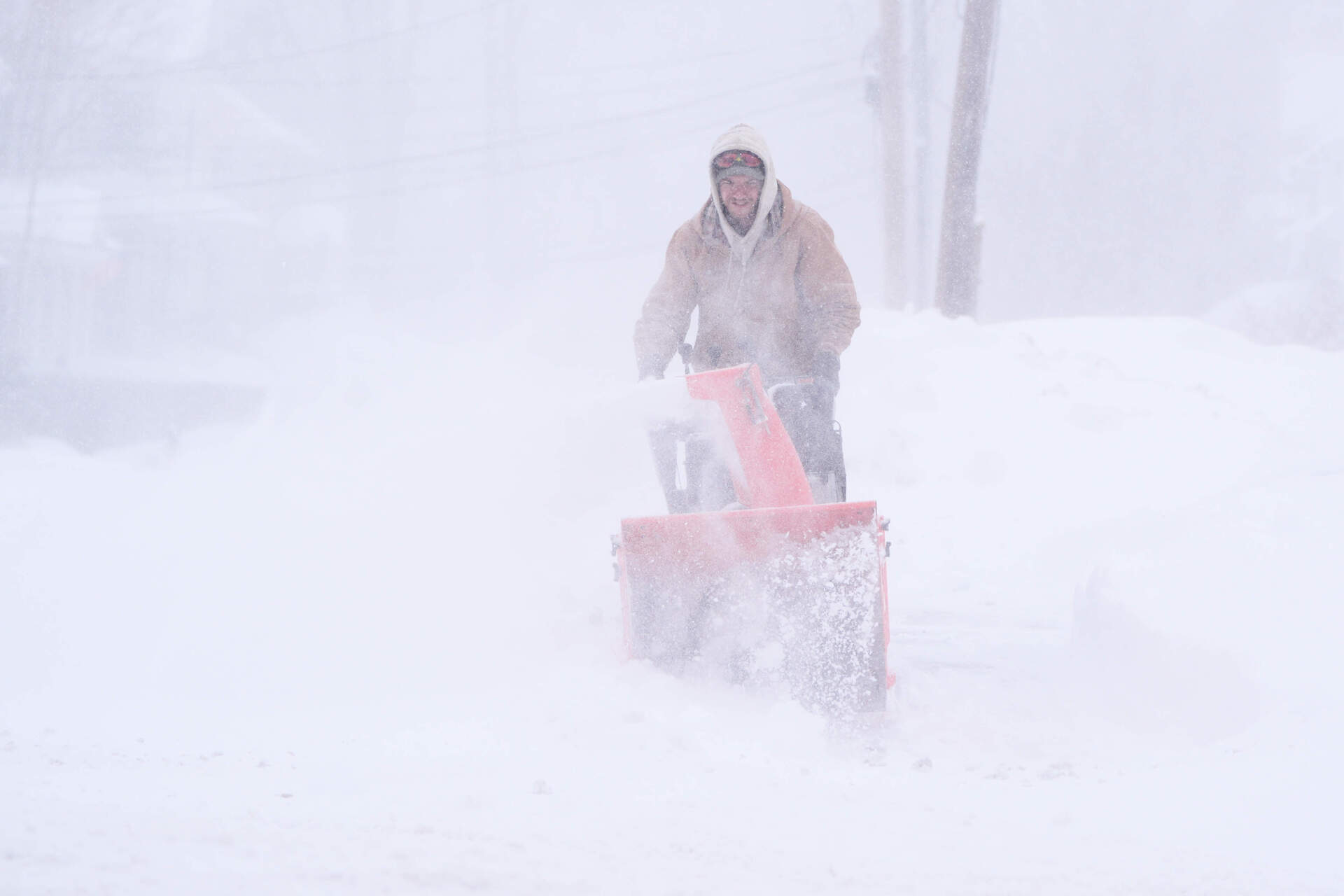 A man snowblows in nearly whiteout conditions on Monday in Derry, New Hampshire. (Charles Krupa/AP)