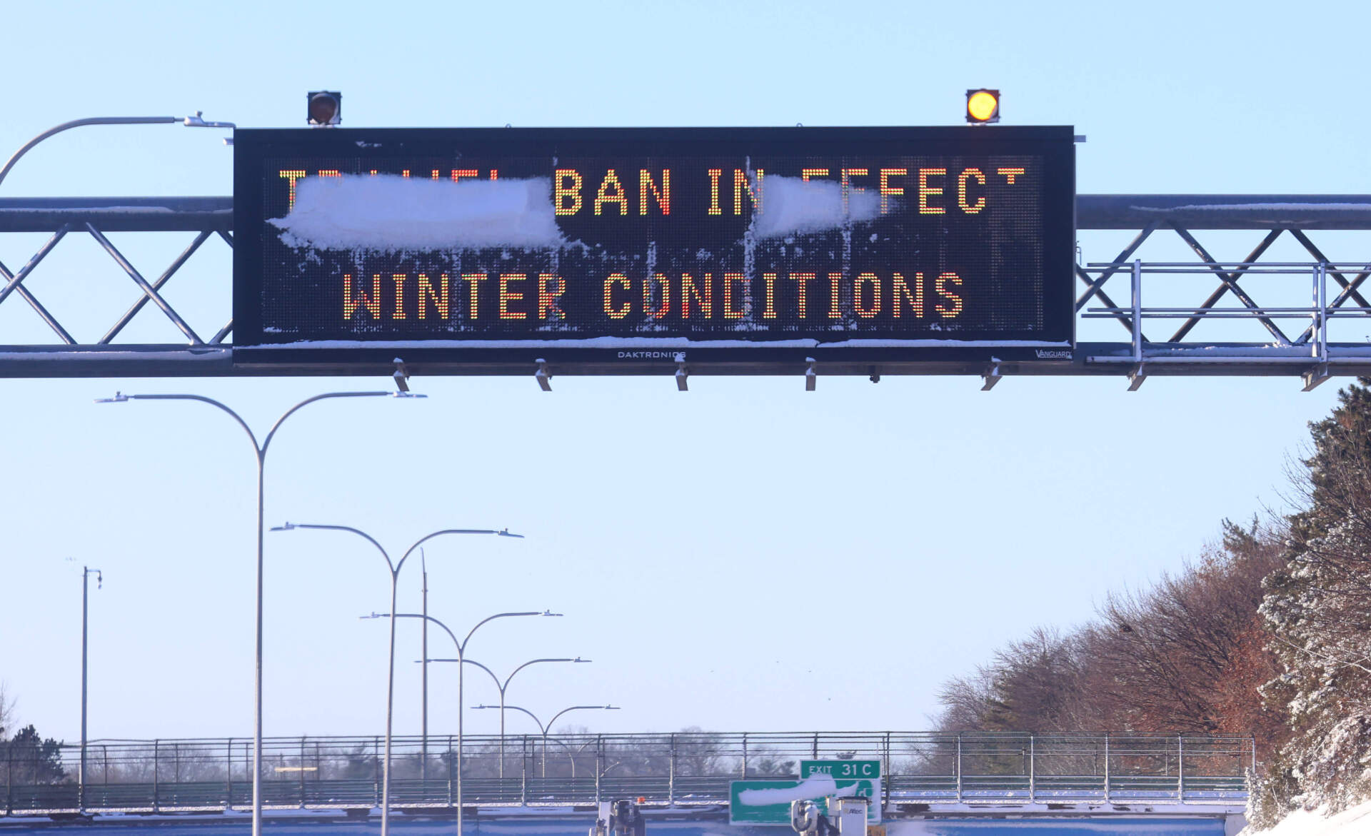 An electronic sign, covered in snow, posts a traffic ban message, Tuesday, Feb. 24, 2026, on Interstate 95 in Warwick, R.I. (Mark Stockwell/AP)