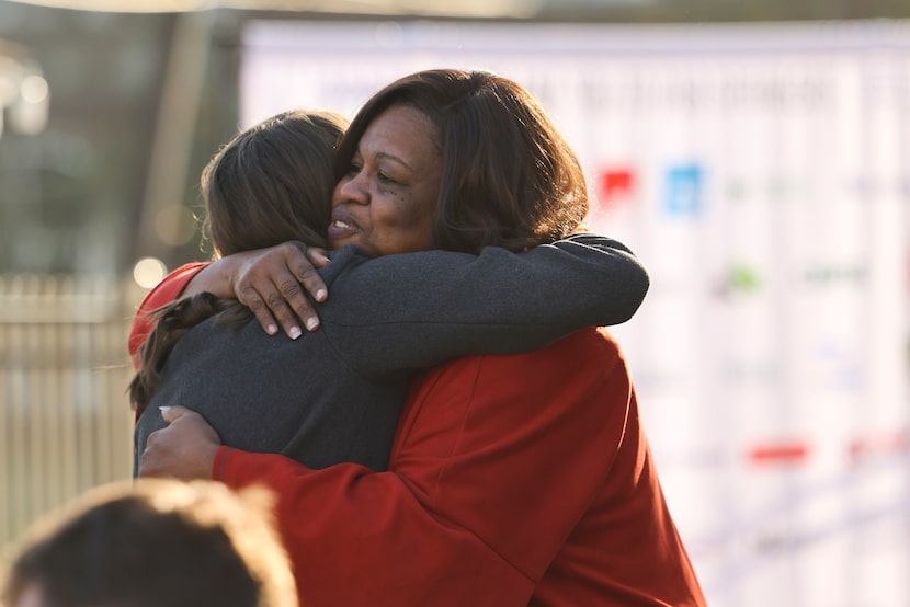 Frances Dean-Smith (right) with Zan Wesley Holmes, Jr. Community Outreach Center, hugs...