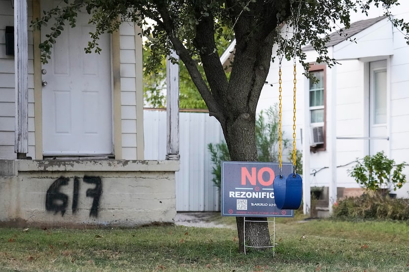 A sign in opposition to a nearby proposed rezoning as a multifamily district near is seen in...