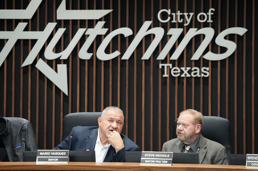Hutchins Mayor Mario Vasquez (left) talks with Mayor Pro Tem Steve Nichols during a special...