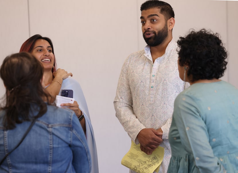 Aroosa Badalpara (left) and Nikhil Kumar conversed with event organizers at the South Asian...