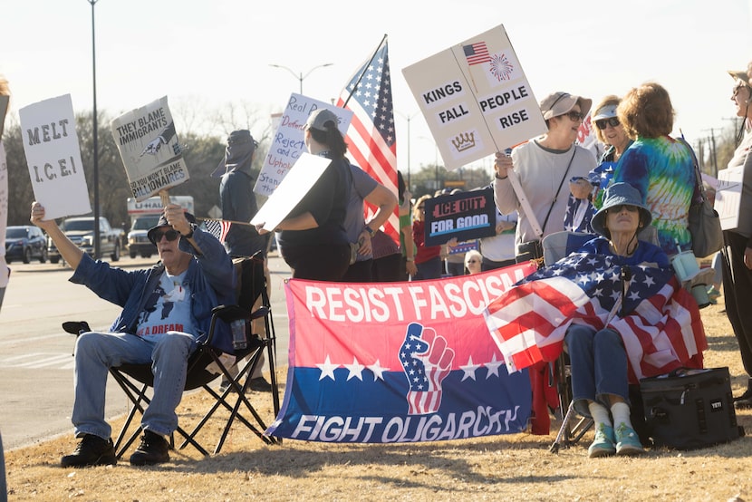 Donny and Sherry Black of Pilot Point sit with their flag that reads “RESIST FASCISM | FIGHT...