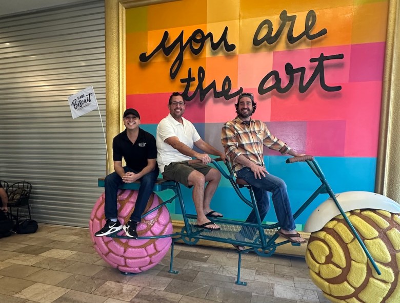 Alamo Biscuit Co owner John Vale and artist Nicholas Monroe ride in style.
