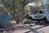 A Pima County sheriff's official stays outside of Nancy Guthrie‘s home on Saturday, Feb. 14,...