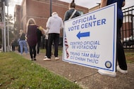 Voters wait in line at the North Dallas High School polling place in Dallas on Election Day...