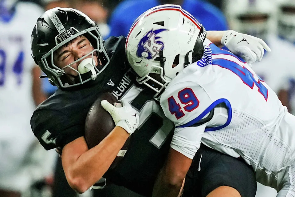 Vandegrift Vipers wide receiver Thomas Buechler (5) makes a reception as C. E. King Panthers linebacker Damian Broussard (49) arrives with the tackle in the second quarter as the Vipers play the Panthers in the Class 6A Division II state semi-final game at McClane Stadium in Waco, Dec. 13, 2025. (Sara Diggins/Austin American-Statesman)