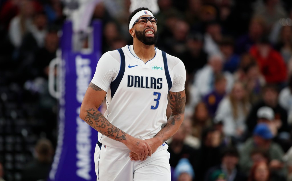 Anthony Davis #3 of the Dallas Mavericks holds his left hand as he reacts to pain after injuring it against Lauri Markkanen during the second half of their game at the Delta Center on January 8, 2026 in Salt Lake City, Utah. 