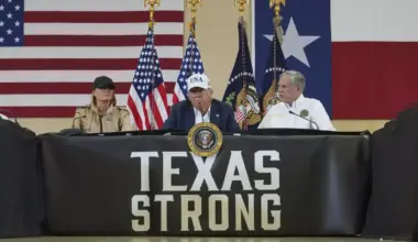 President Donald Trump speaks as first lady Melania Trump, left, and Texas Gov. Greg Abbott listen during a roundtable discussion with first responders and local officials in Kerrville, Texas earlier this month after the floods.