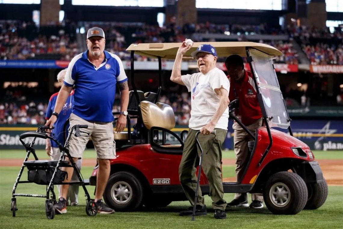 Doland Maner, former Arlington City Councilman, throwing out the first pitch at a Texas Rangers game in 2023 in honor of his 100th birthday. Mayor Jim Ross pictured at left.