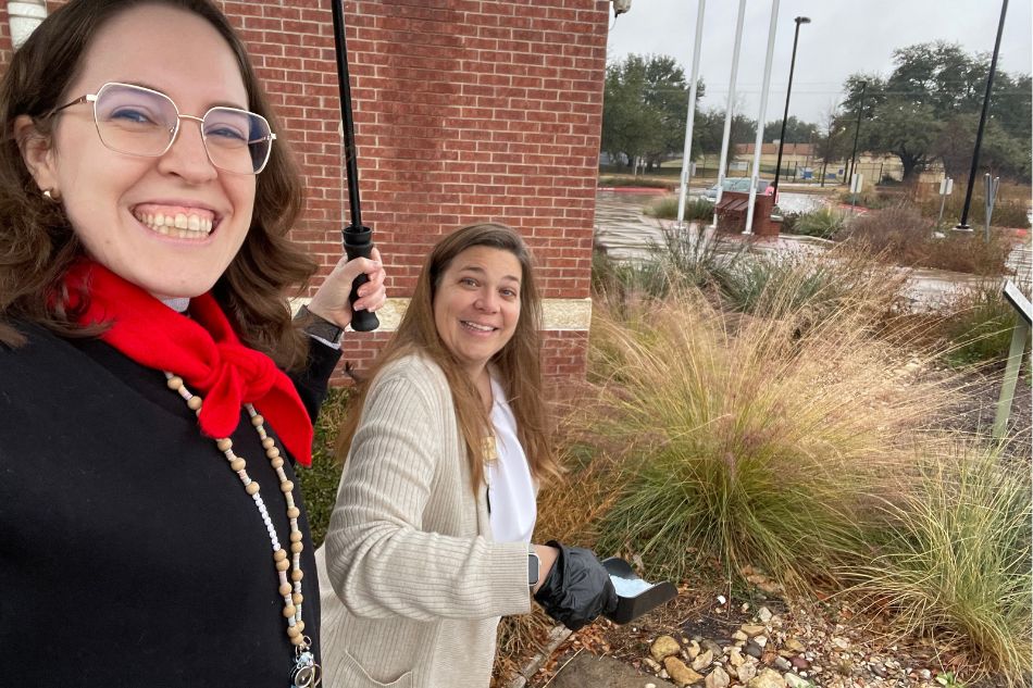 Library employees apply salt to the sidewalk at the Southwest Branch Library on Jan. 23, 2026.
